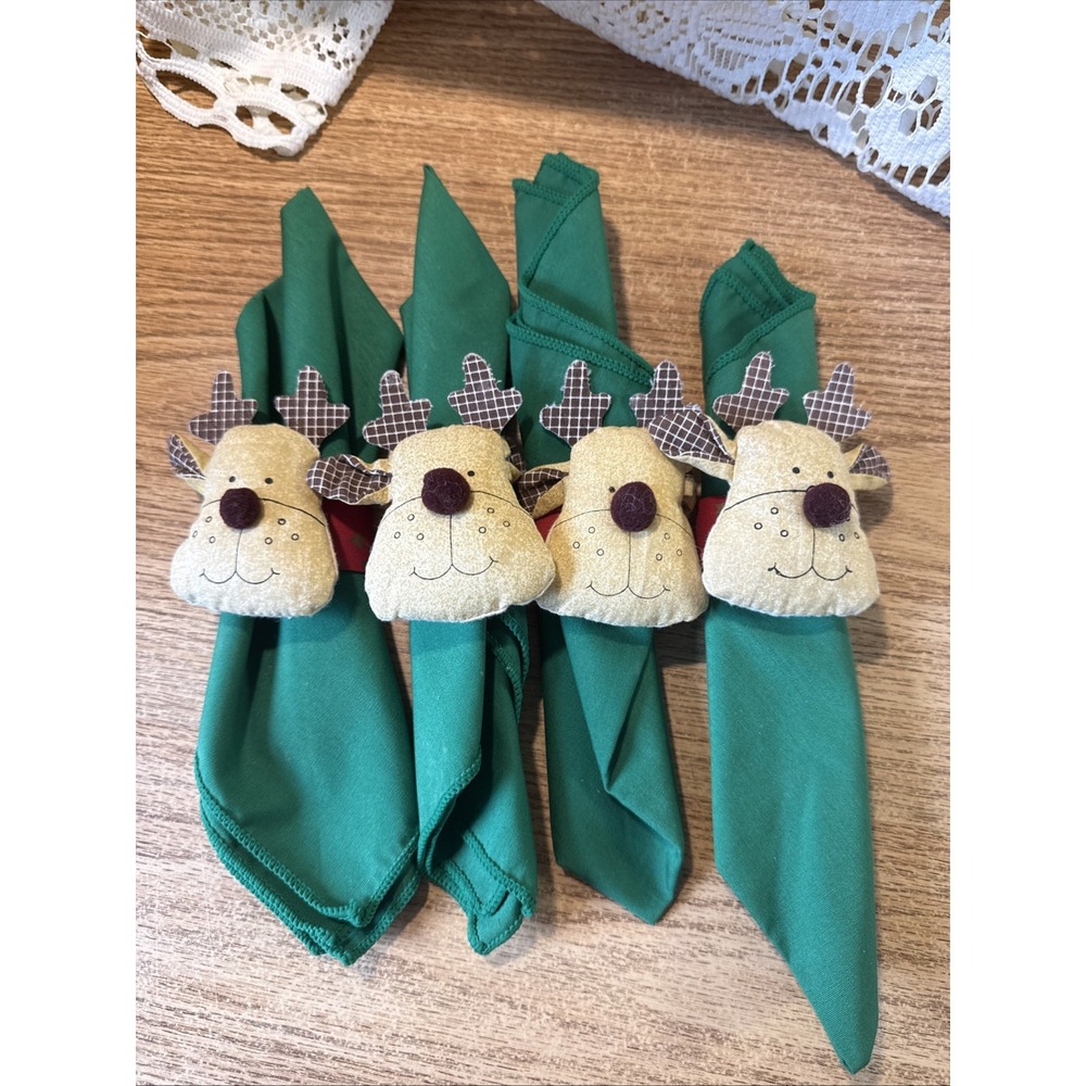 festive reindeer napkin rings wrapped around vibrant green fabric napkins